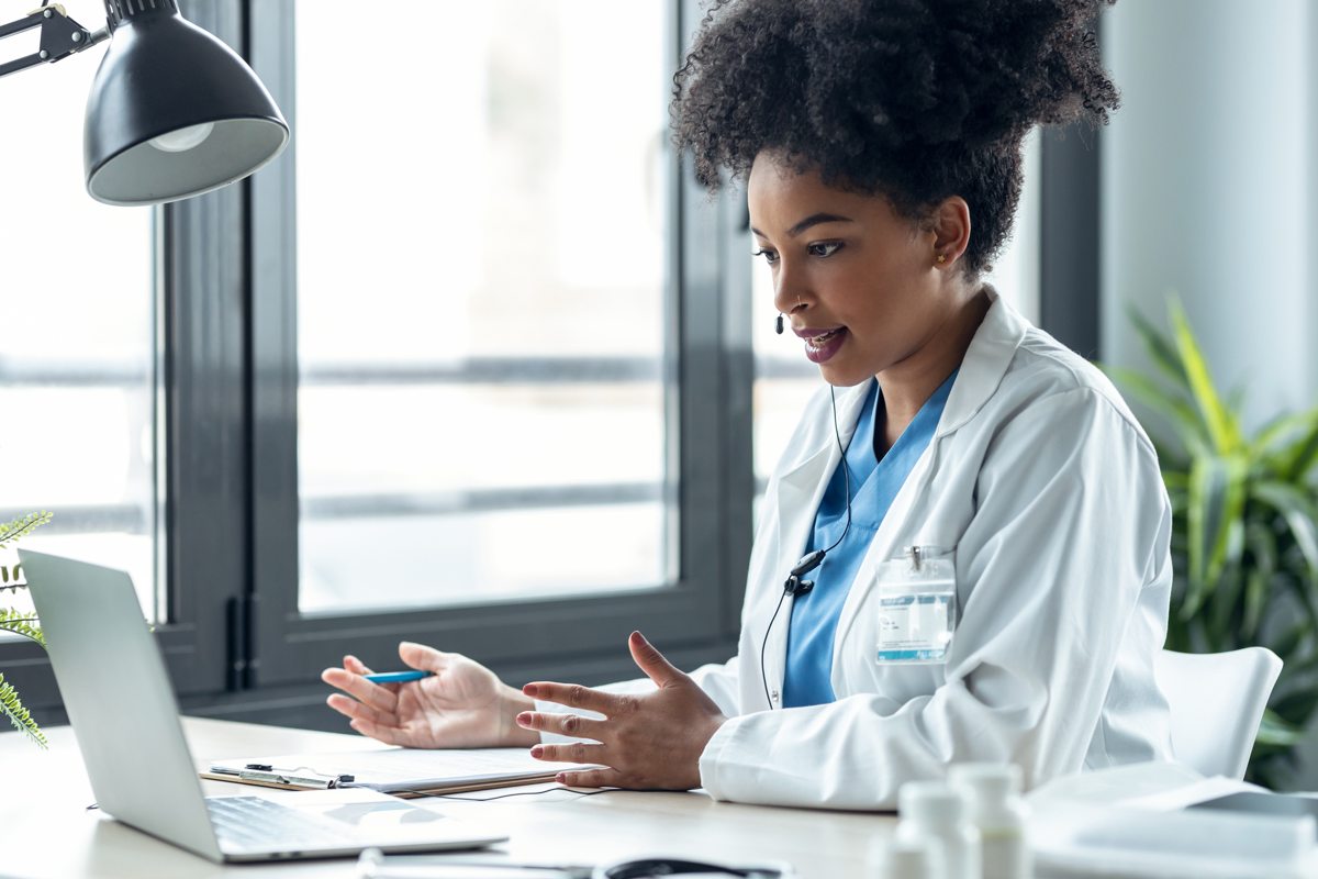 A clinician works at a computer in a medical office.