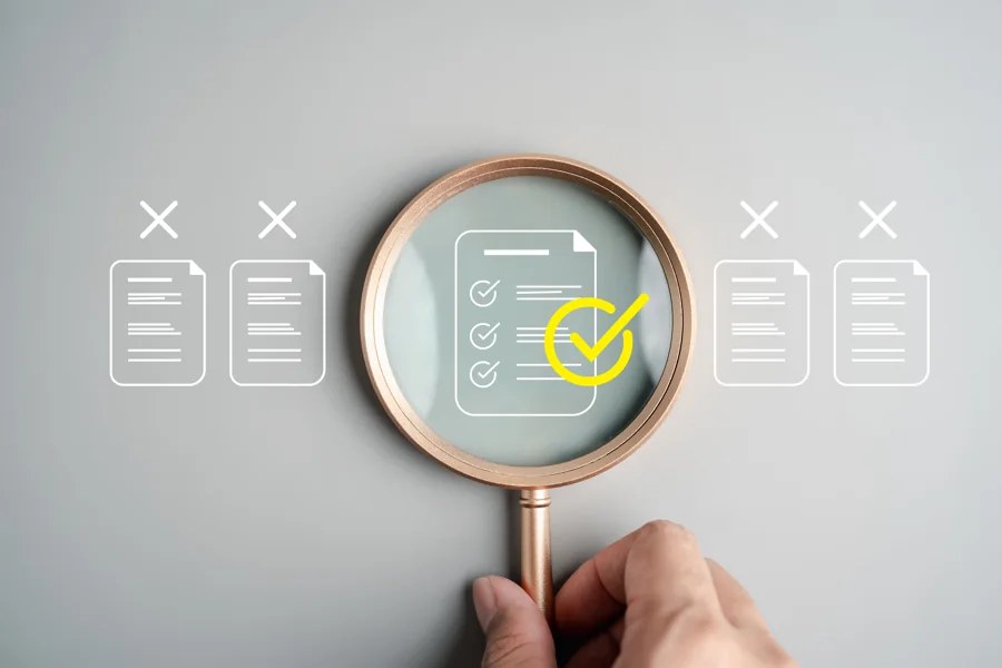 A magnifying glass highlights a checked document among application records.